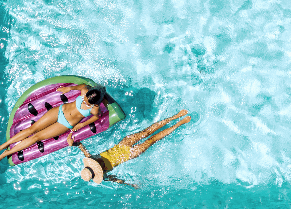 women on floats in pool