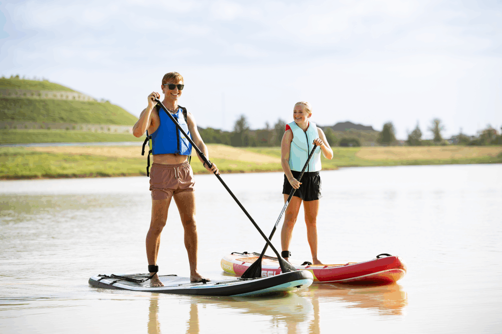 two kids paddle board at The Grand Prairie