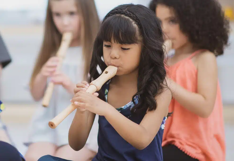 little girl playing recorder