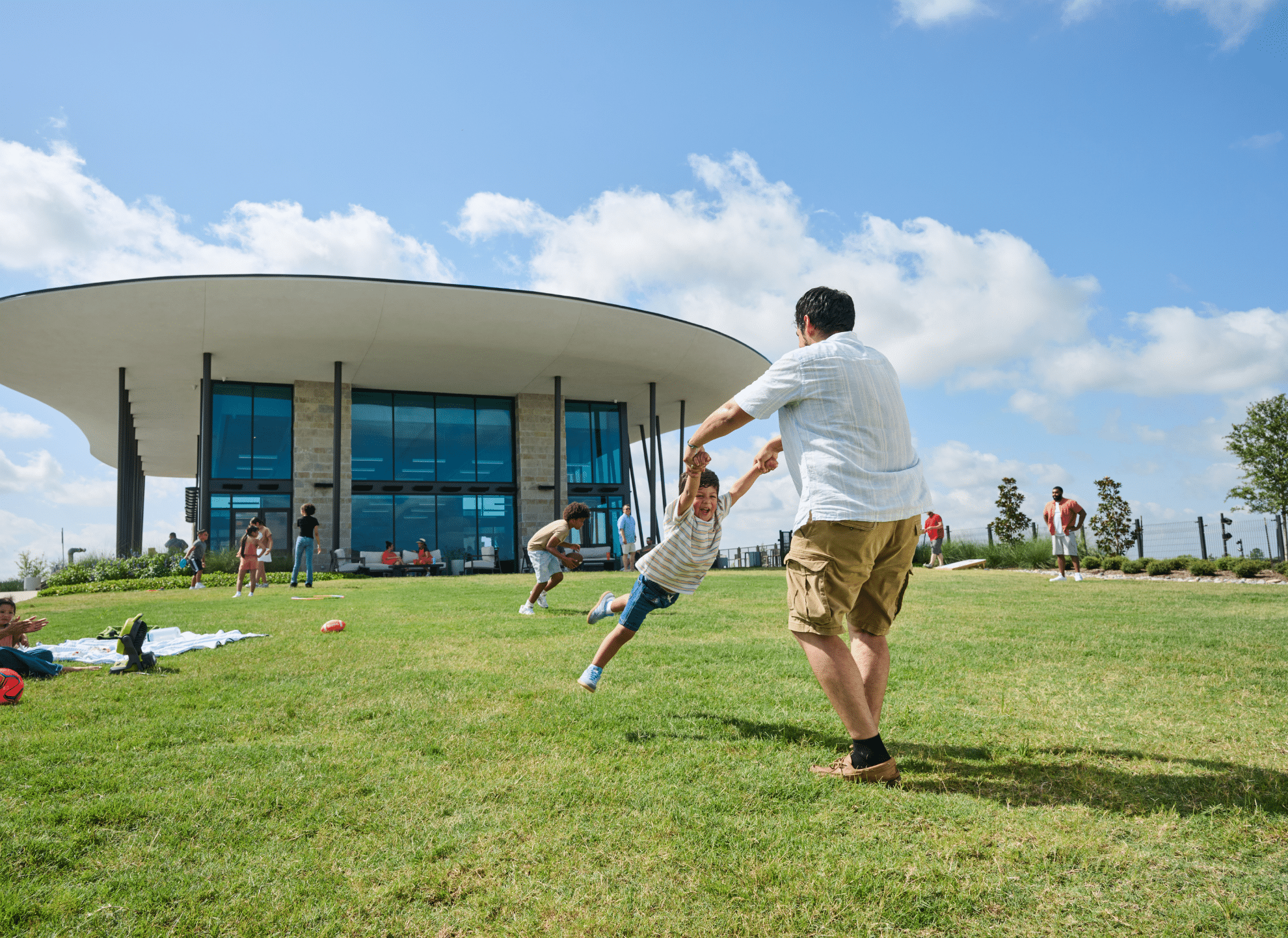 Father and son playing on the lawn at The Overlook amenity center